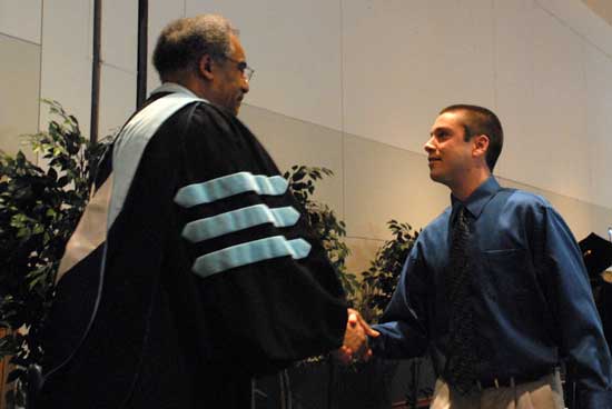 Dr. Edgar Farmer congratulating 2013 Phi Kappa Phi initiate.